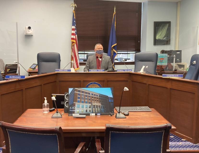 Sen. Mike Shower, R-Wasilla, watches as his aide Scott Ogan gives a presentation by video on Senate Bill 39, a measure making changes in the voting system during a Senate State Affairs Committee meeting on April 15, 2021, in the Alaska State Capitol in Juneau, Alaska. The other senators on the committee were participating by videoconference. (Photo by Andrew Kitchenman/KTOO and Alaska Public Media)