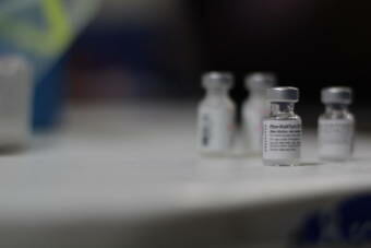 Vials of Pfizer’s COVID-19 vaccine sit on a table at a clinic at the Cooper Landing school last week. After they’re opened, the vials must be used within six hours or thrown away. (Nat Herz/Alaska Public Media)