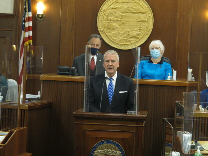Alaska Republican U.S. Sen. Dan Sullivan, center, speaks to a joint session of the Alaska Legislature on Monday, May 3, 2021, in Juneau, Alaska. Pictured behind Sullivan are, from left, Senate President Peter Micciche and House Speaker Louise Stutes. (AP Photo/Becky Bohrer, Pool)