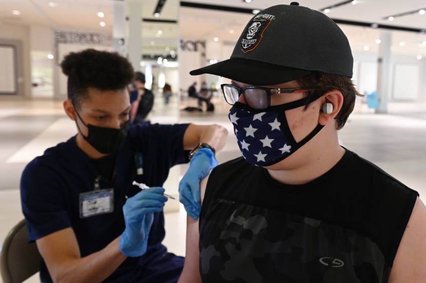 Josh Gardner, a nationally certified medical assistant, gave Kael Harrod, 15, his first dose of the Pfizer vaccine at the Visit Healthcare vaccination site in the Dimond Center on Thursday, May 13, 2021. (Bill Roth / ADN)