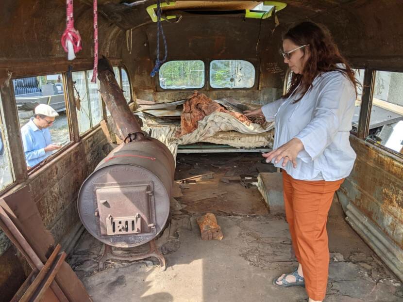 Museum of the North Senior Collections Manager Angela Linn explains conservation work needed to stabilize the floor of the bus and other parts of its interior. (Photo by Tim Ellis/KUAC)