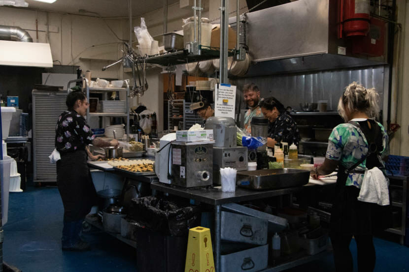 Claudette Zepeda, Rachel Barril, Beau Schooler, Amara Enciso and Aims Villanueva-Alf cook in the kitchen of In Bocca Al Lupo for their event "Dinner with Friends: Womxn of Power edition" on June 26. (Photo by Lyndsey Brollini/KTOO)