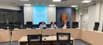 Sen. Lyman Hoffman, D-Bethel; Rep. Jonathan Kreiss-Tomkins, D-Sitka; and Rep. Kevin McCabe, R-Big Lake, attend a comprehensive fiscal plan working group meeting on July 22, 2021, at the Anchorage Legislative Information Office. (Photo by Andrew Kitchenman/KTOO and Alaska Public Media)