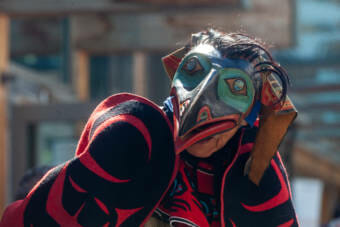 Nathan Jackson Yéil Yádi (Raven Child), leader of the Lukaax.ádi clan peforms with the clan dancers during a stamp dedication for artist Rico Lanáat’ Worl new postage stamp "Raven Story," on Friday, July 30, 2021 in Juneau, Alaska. (Photo by Rashah McChesney/KTOO)