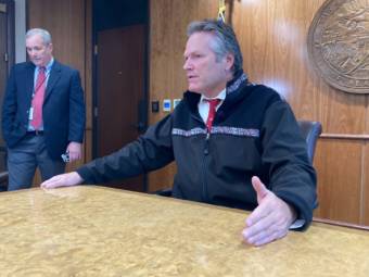 Gov. Mike Dunleavy talks with reporters on Sept. 14, 2021 in the cabinet room in the Alaska State Capitol in Juneau, Alaska. He discussed several issues related to the end of the third special session of the year. He called for a fourth special session later in the day. Dunleavy spokesperson Jeff Turner is on the left. (Photo by Andrew Kitchenman/KTOO and Alaska Public Media)