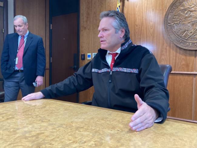 Gov. Mike Dunleavy talks with reporters on Sept. 14, 2021 in the cabinet room in the Alaska State Capitol in Juneau, Alaska. He discussed several issues related to the end of the third special session of the year. He called for a fourth special session later in the day. Dunleavy spokesperson Jeff Turner is on the left. (Photo by Andrew Kitchenman/KTOO and Alaska Public Media)