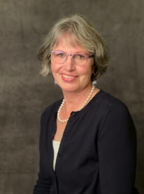 Kathy Callahan, Bartlett Regional Hospital's interim CEO, poses in front of a brown background