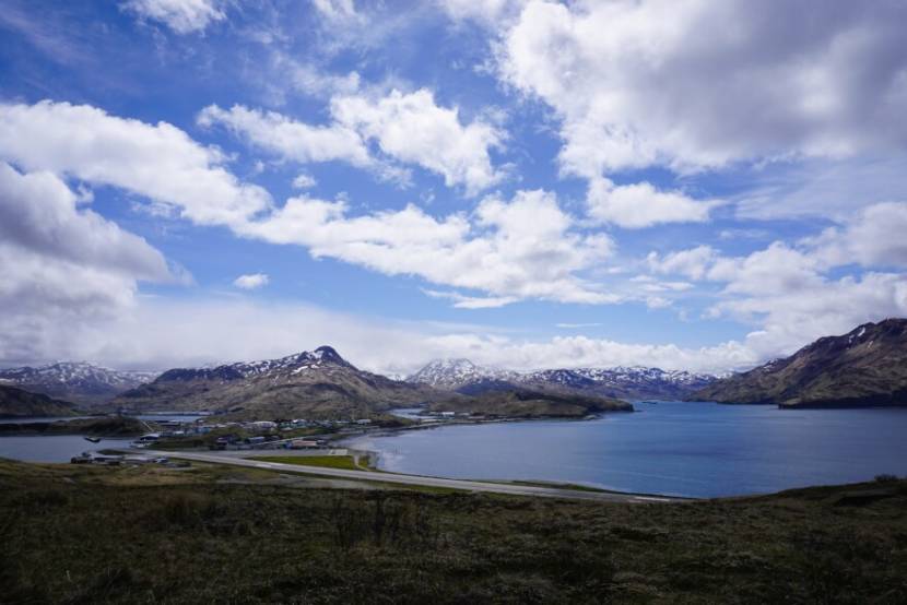 A view of the single-runway Unalaska airport with Dutch Harbor behind it.