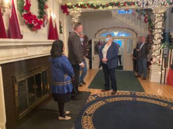 Gov. Mike Dunleavy and Juneau Mayor Beth Weldon speak just before the governor's holiday open house began on Dec. 7, 2021, at the Governor's Mansion in Juneau. Alaska First Lady Rose Dunleavy is on the left. It was the first open house in two years, due to the pandemic. (Photo by Andrew Kitchenman/KTOO and Alaska Public Media)