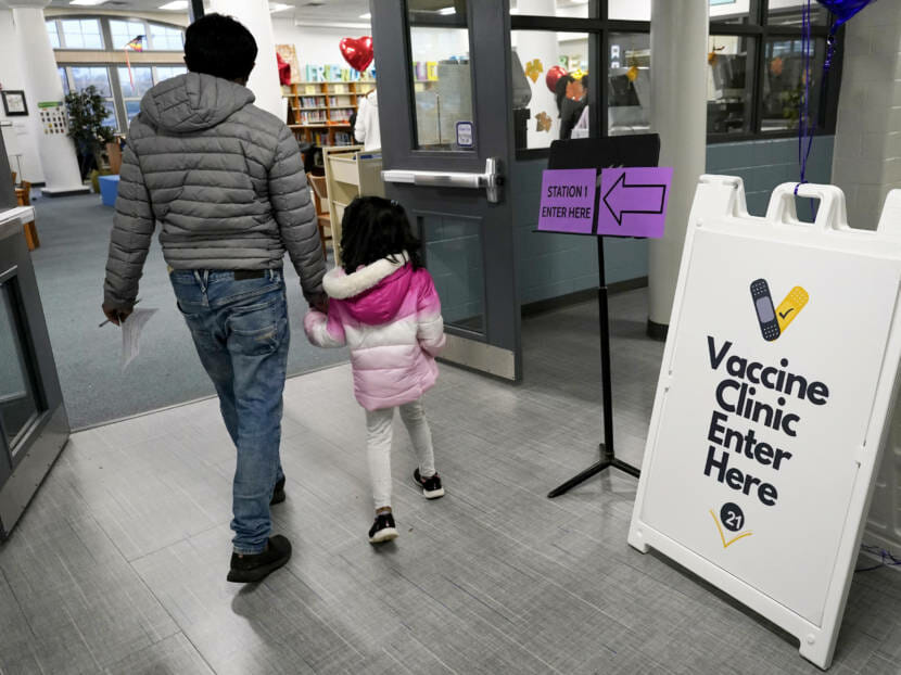 A parent walking with a child into a vaccine clinic