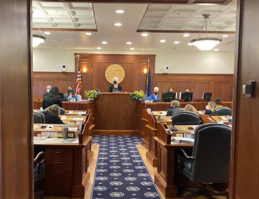 Alaska House Speaker Louise Stutes (R-Kodiak), center, listens as Rep. Cathy TIlton (R-Wasilla), right with back to camera, speaks in the House chamber in the Alaska State Capitol in Juneau on the first day of the session, Jan. 18, 2022. (Photo by Andrew Kitchenman/KTOO and Alaska Public Media)