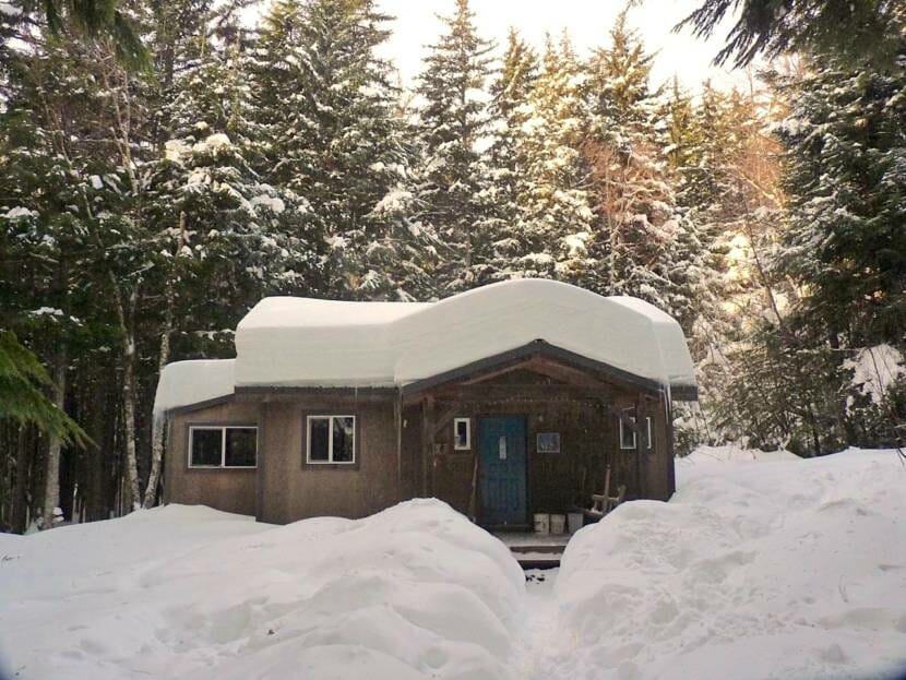 A small hose with about two feet of snow on its roof