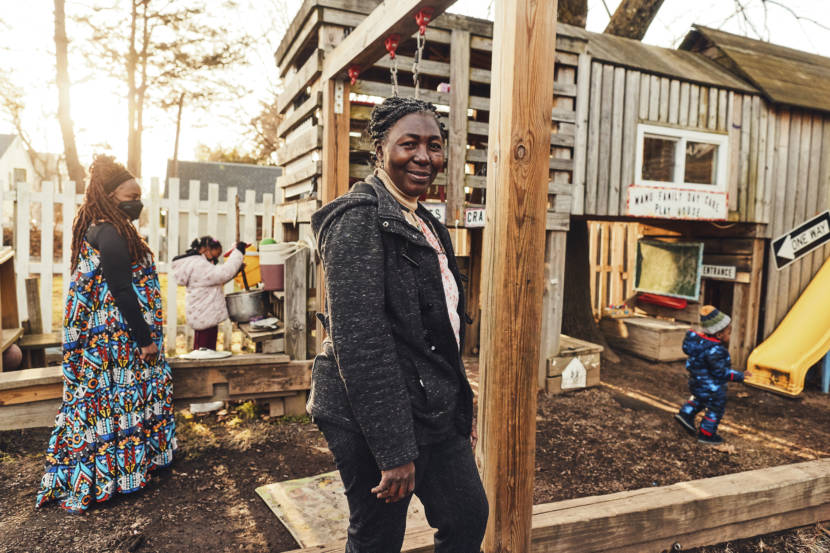 Two women chaperoning children who are playing on a playground