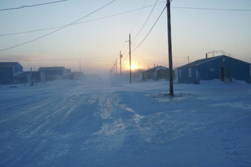 A wind-whipped village street in winter