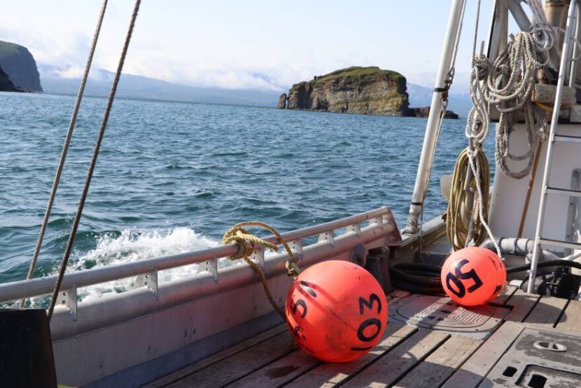 rocky islands seen from the deck of a fishing boat