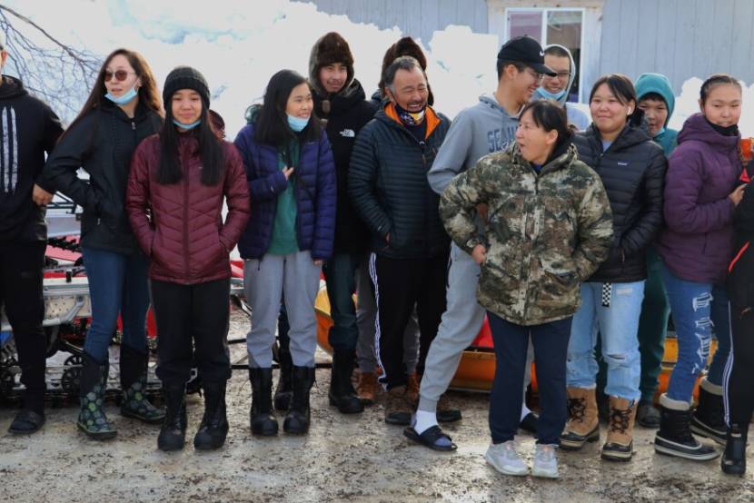 A group photo of students and chaperones standing outside