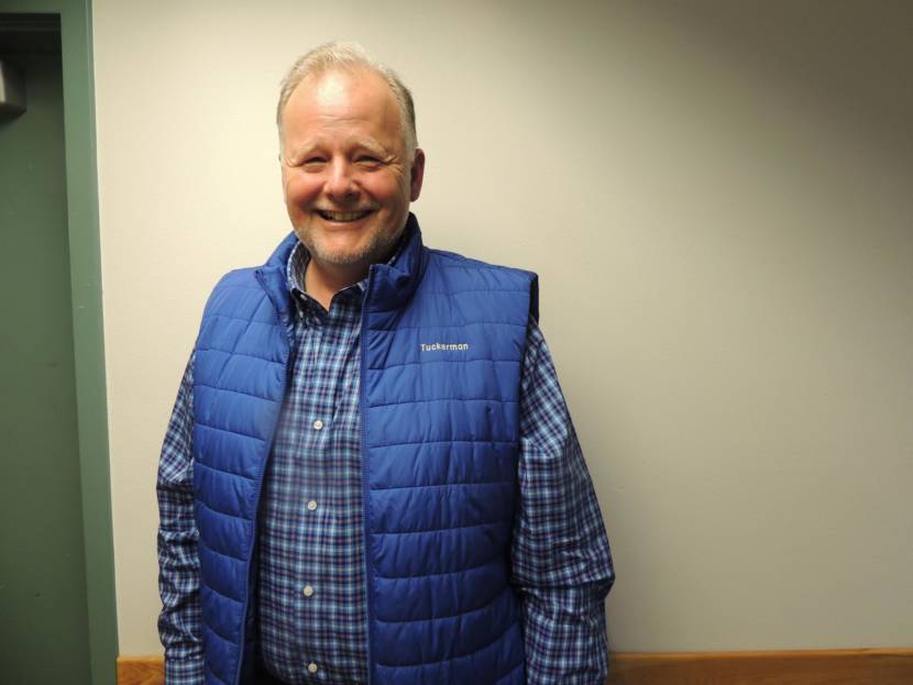 A man wearing a blue vest that says "Tuckerman" on it