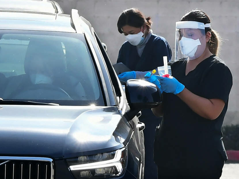 Health care workers at a drive-through covid testing station