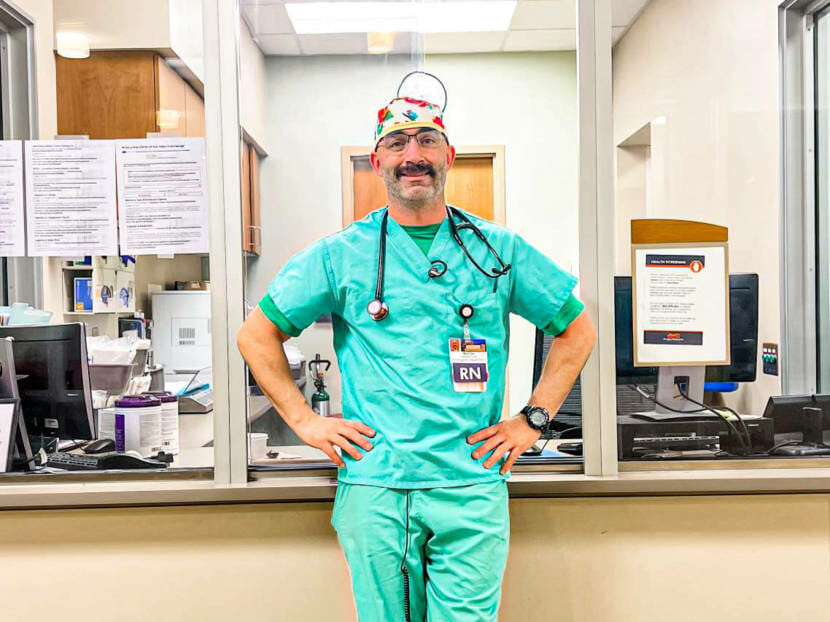 Matt Paveglio stands, wearing his scrubs, during his shift at Alaska Regional