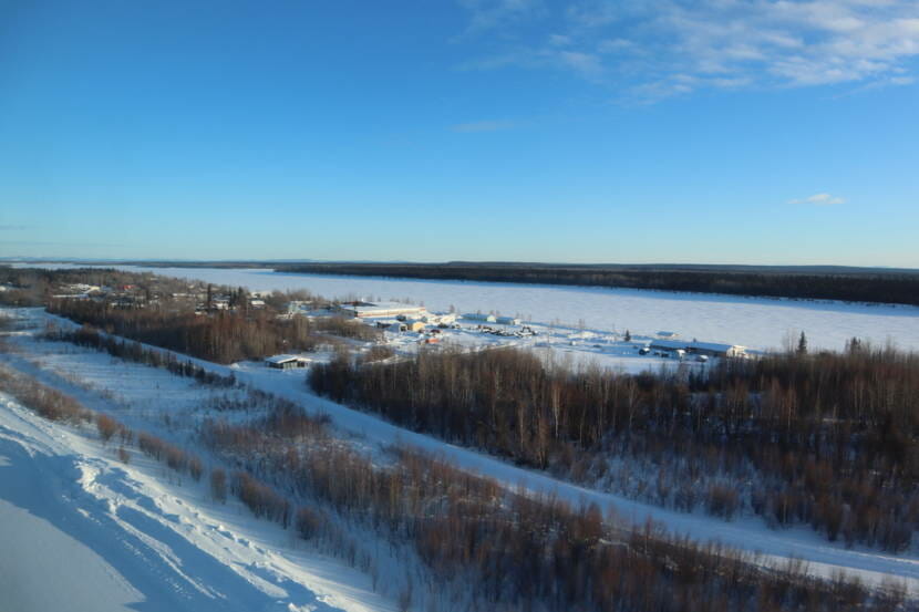 A small community on the banks of a large, frozen river