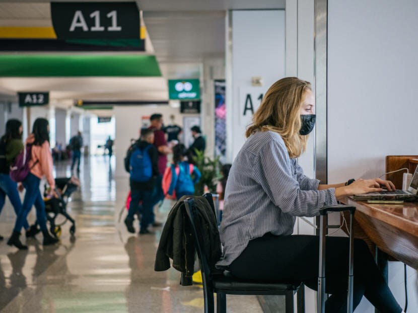 Masked people in an airport terminal