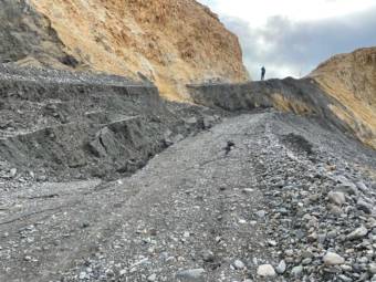 A section of gravel road that has slidden several feet below where it should be