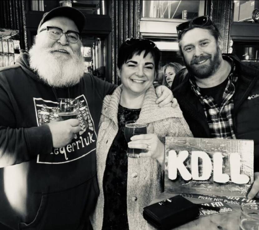 A black-and-white photo of two men and and a woman