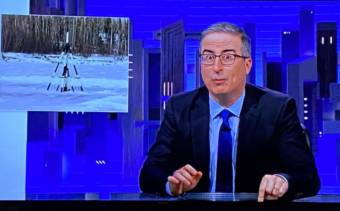 John Oliver at his desk, with a photo of the Nenana tripod inset