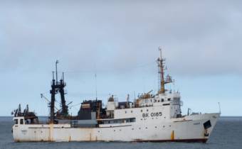 A side view of a white research ship at sea.
