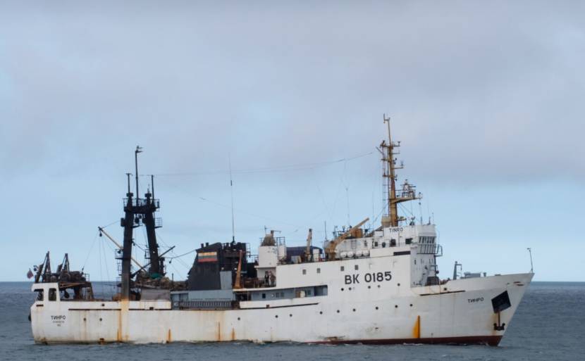 A side view of a white research ship at sea.