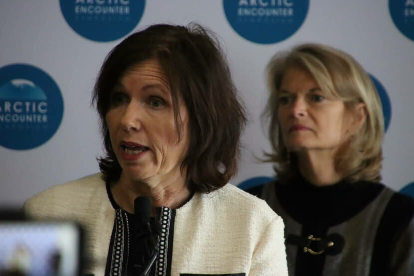 The Norwegian ambassador speaks into a microphone while Sen. Lisa Murkowski stands behind her.