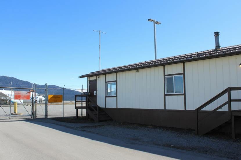 A tan-and-brown trailer at an airport