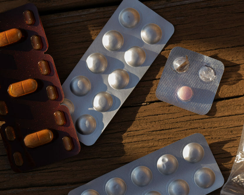 Blister packs of pills strewn on a table
