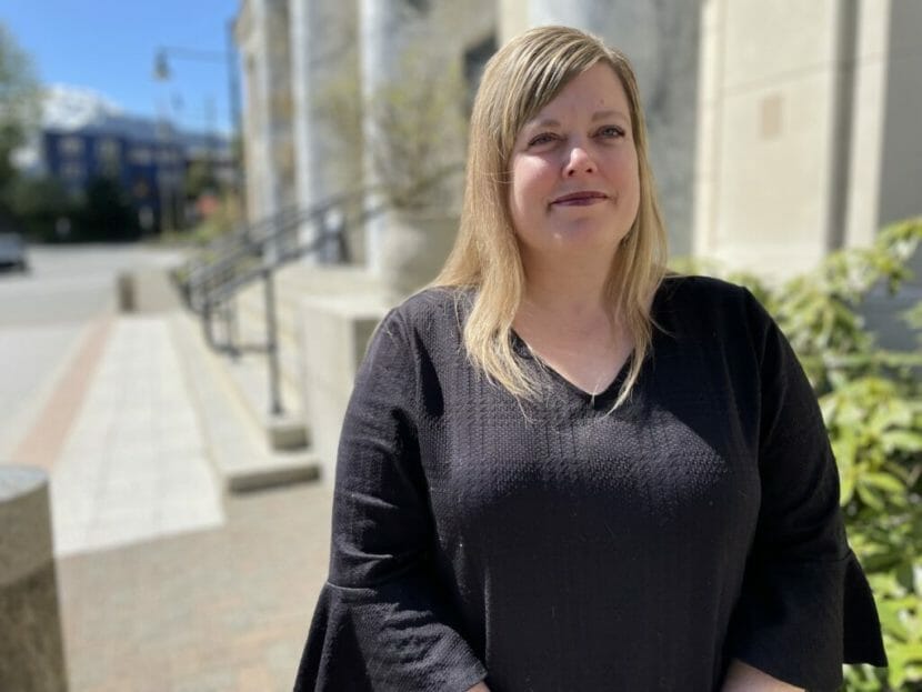 A portrait of a woman standing outside the Alaska Capitol