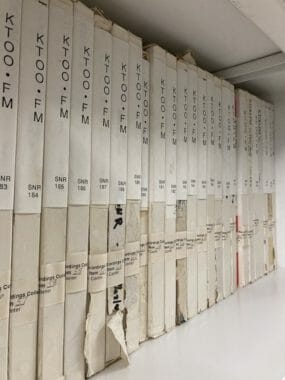 A shelf of old tapes labeled "KTOO" and "SNR"