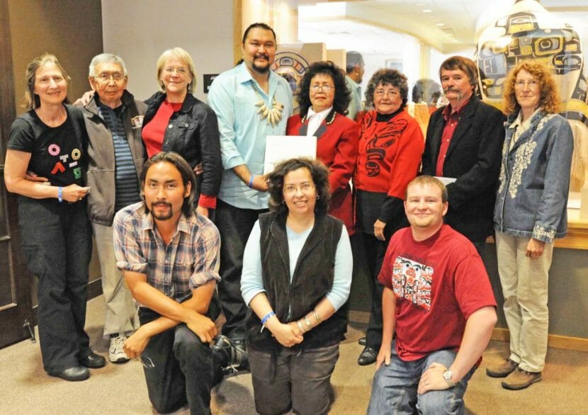 A group photo of 11 people, standing and kneeling