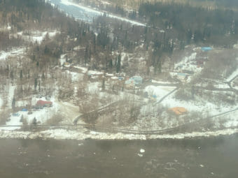 An aerial photo of a village at a bend in a river