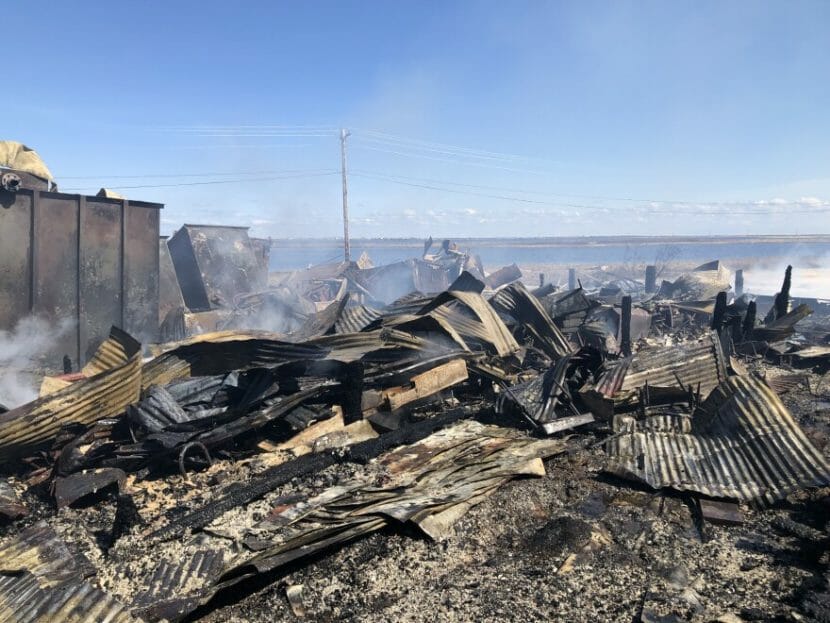 Smoking rubble, including twisted sheets of corrugated roofing