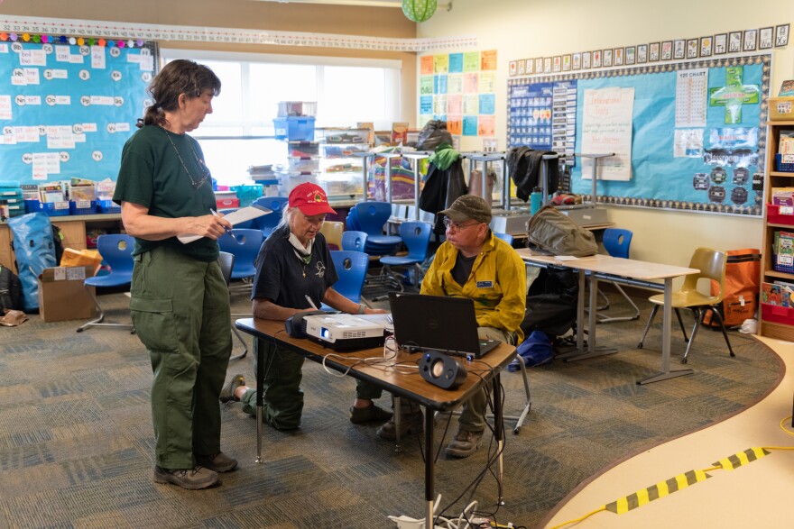 Firefighters conferring with each other in a classroom