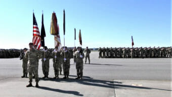 Soldiers holding flags at a military ceremony