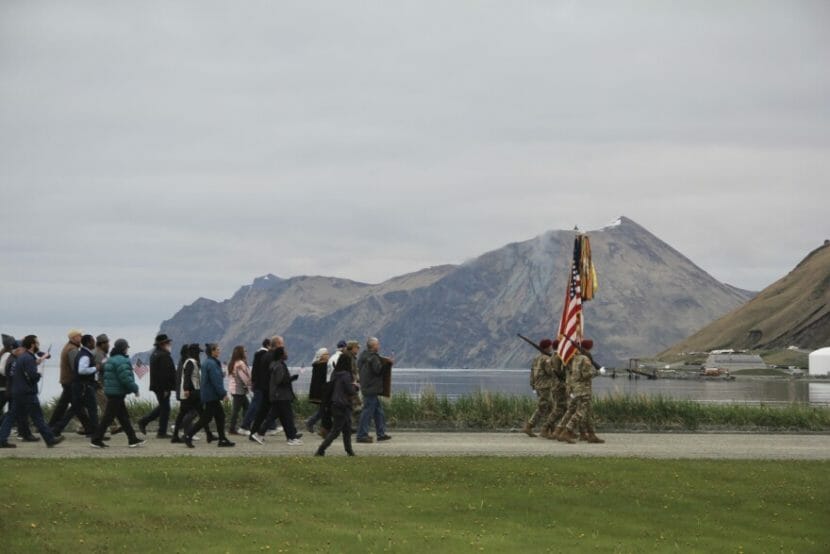A military procession with a mountain in the background