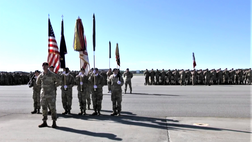 Soldiers holding flags at a military ceremony