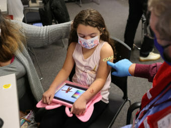 A young girl getting a shot