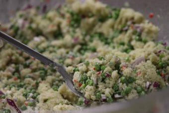 A spoon in a bowl of herring egg salad