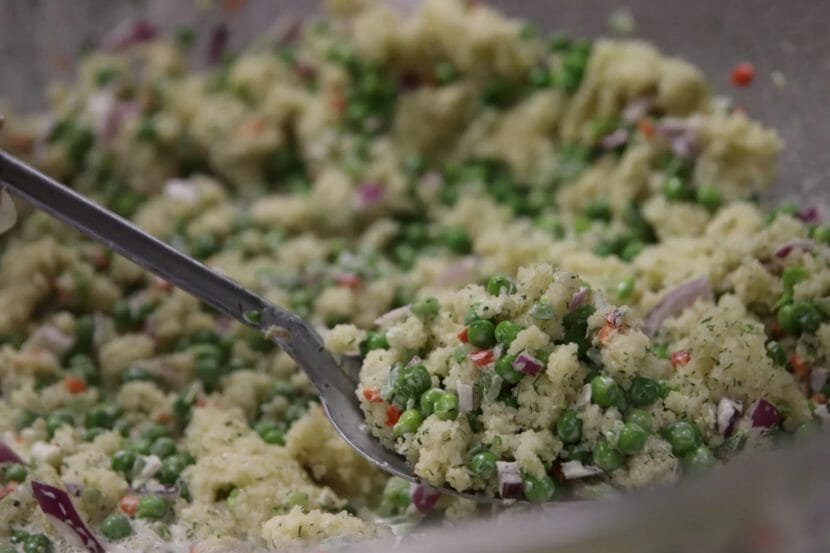 A spoon in a bowl of herring egg salad