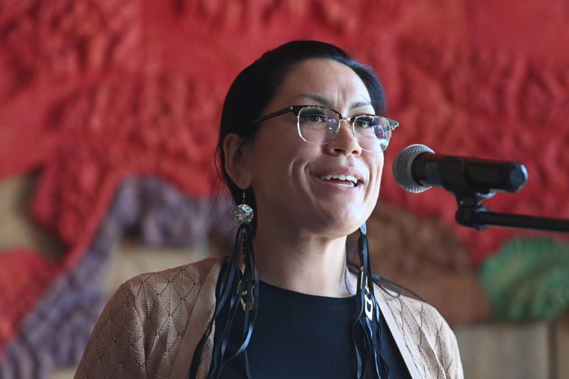 Tiffany Zulkosky standing and speaking into a microphone