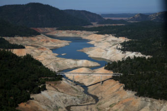 A bridge over a lake that has nearly gone dry