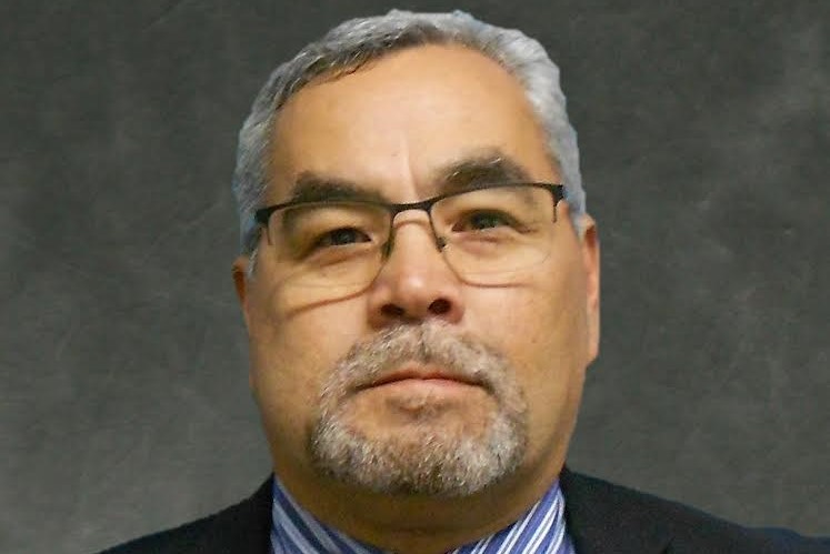 A headshot of a middle-aged man