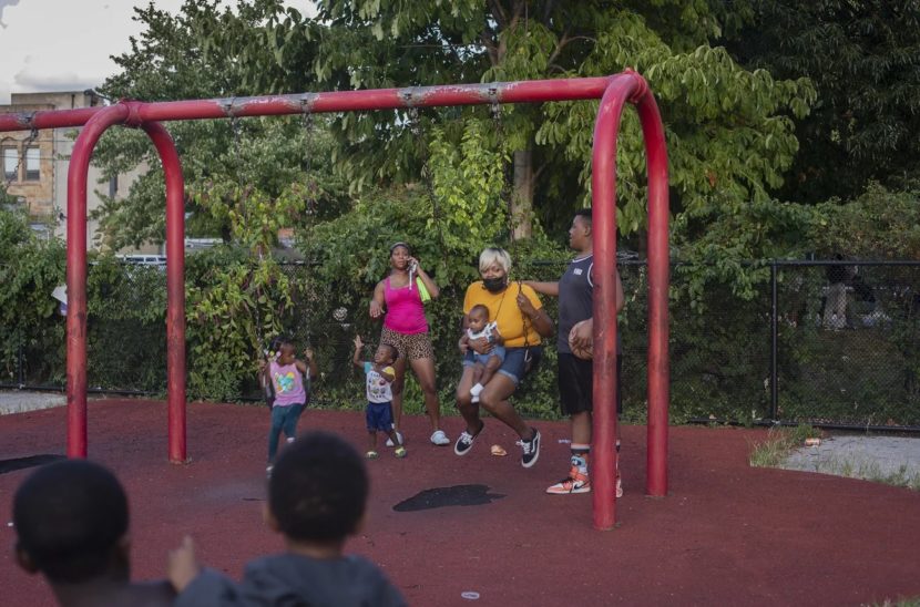 Families playing at a swingset