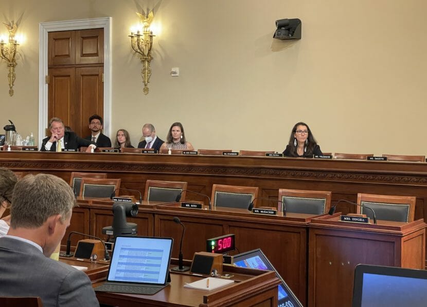 Mary Peltola sits listening in a committee room that has many empty seats